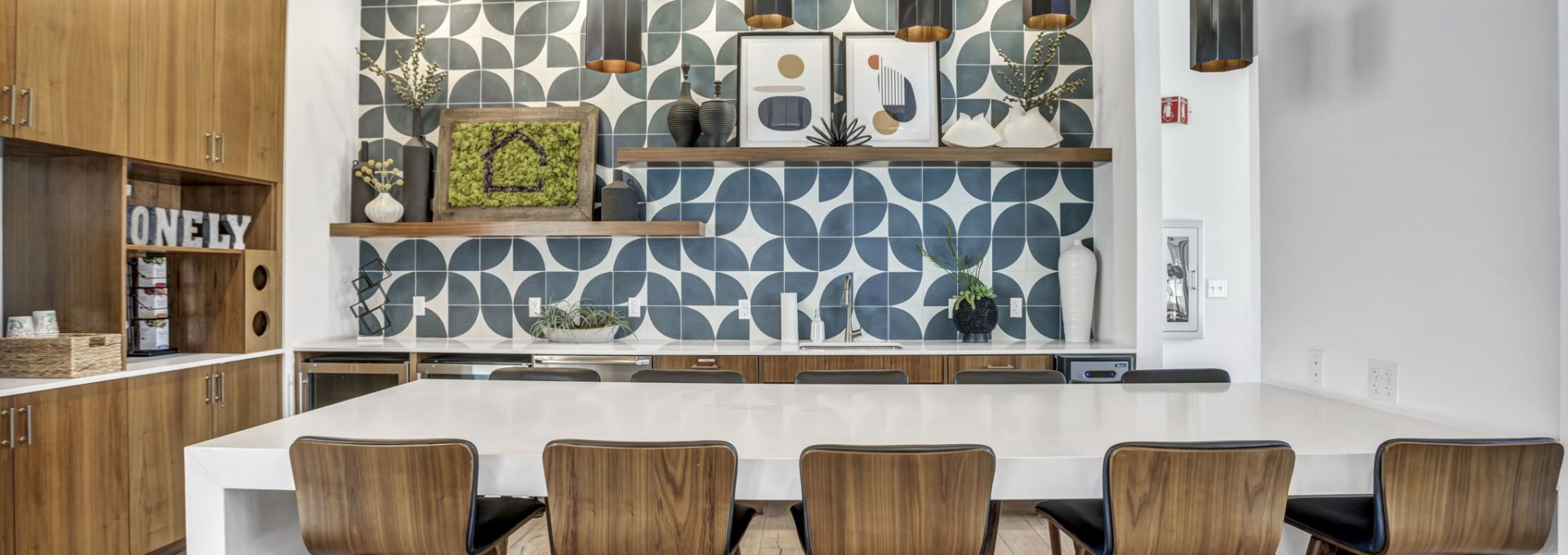 a kitchen with wood stools and a large table at The  Conley