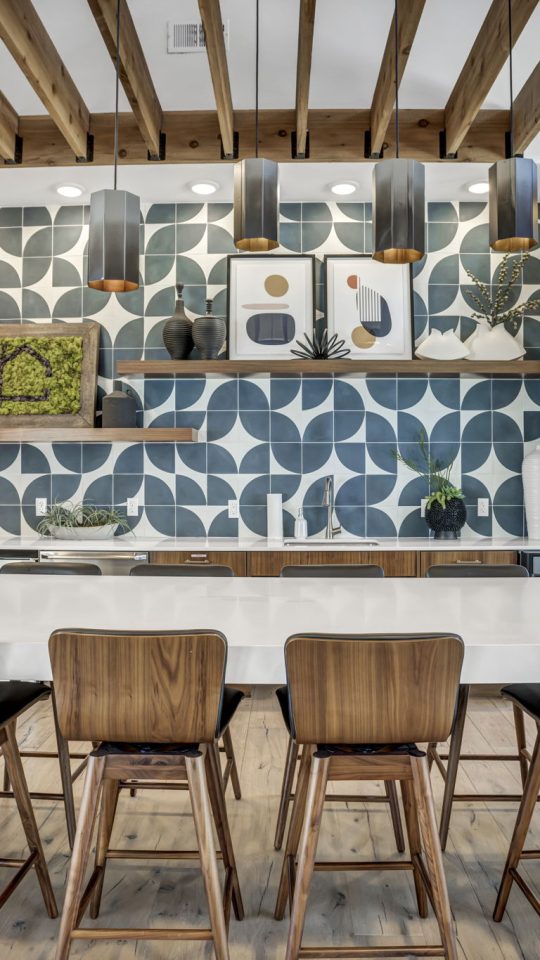 a kitchen with wood stools and a large table at The  Conley