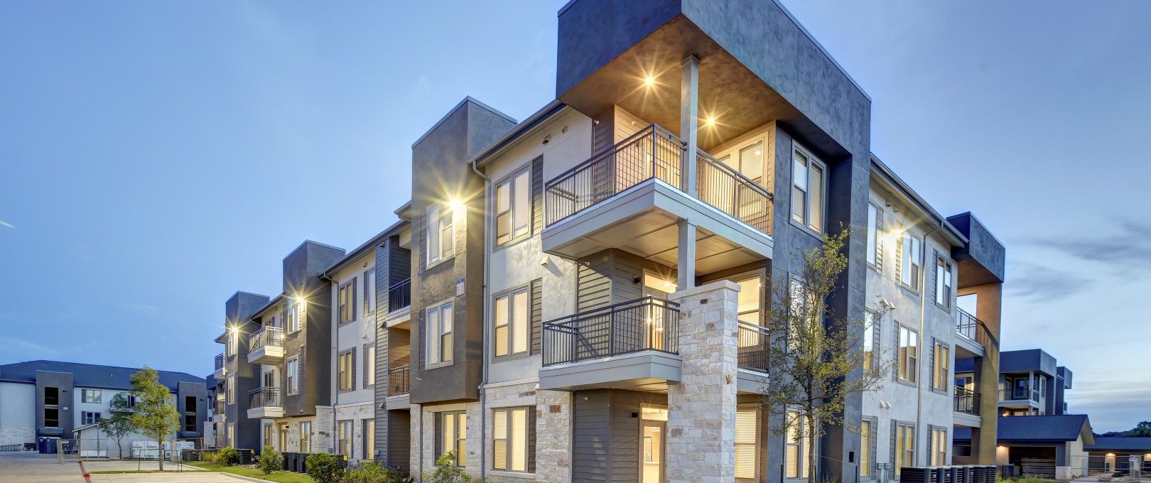 the exterior of an apartment complex at dusk at The  Conley