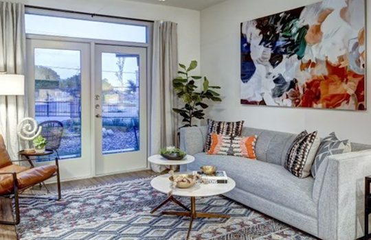 a living room with a large picture window and a couch at The  Conley