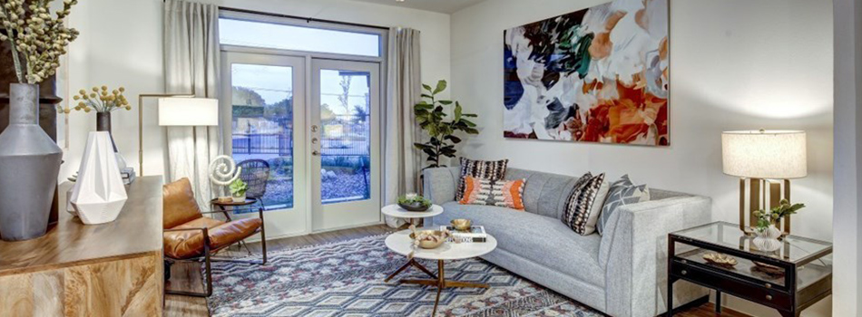 a living room with a large picture window and a couch at The  Conley