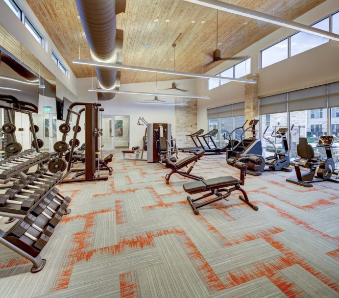 a gym with exercise equipment and a large window at The  Conley