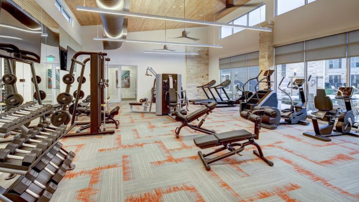 a gym with exercise equipment and a large window at The  Conley