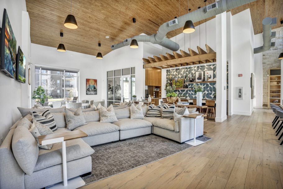 a large living room with wooden floors and white couches at The  Conley