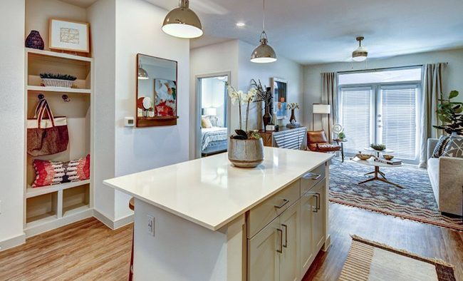 a kitchen with a large island and a large living room at The  Conley