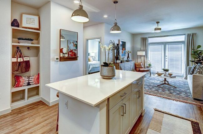 a kitchen with a large island and a large living room at The  Conley